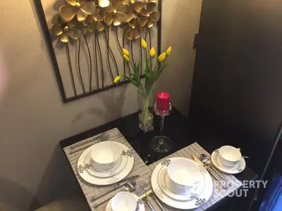 Elegant dining setup with floral decor and modern tableware in cozy interior