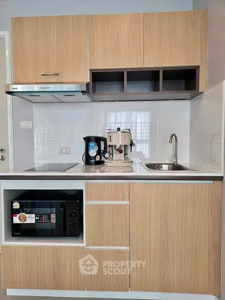 Modern compact kitchen with wooden cabinets and built-in appliances