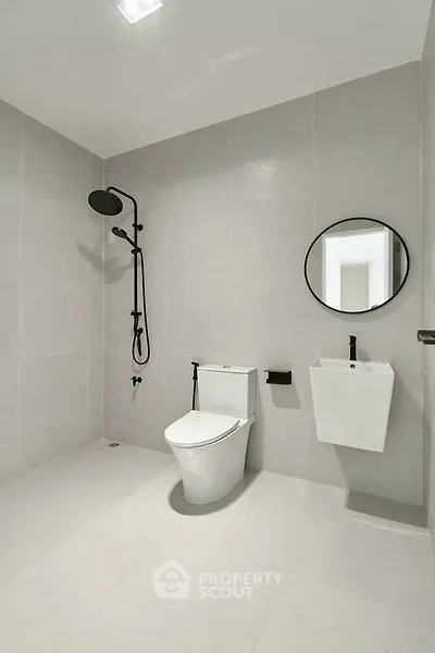 Modern minimalist bathroom with sleek fixtures and neutral tones.