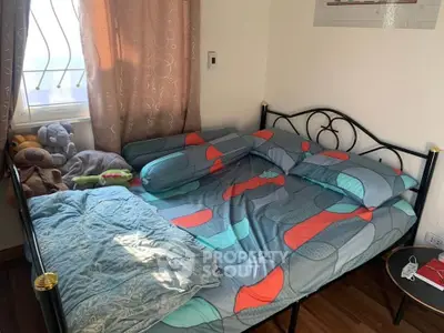 Cozy bedroom with stylish bedding and natural light from window