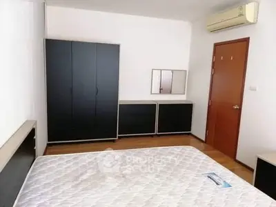 Spacious bedroom with modern furniture and air conditioning in a stylish apartment.