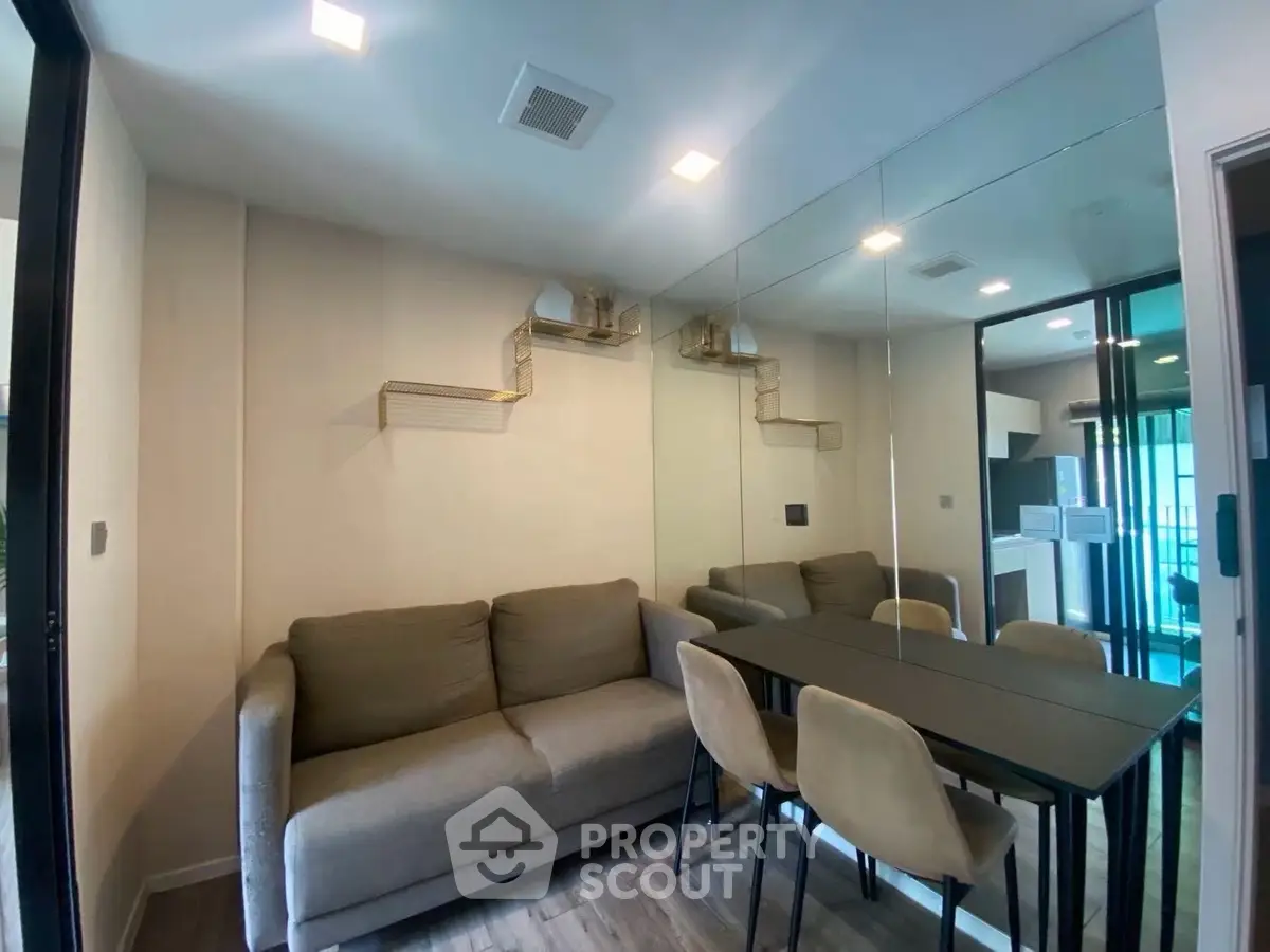 Modern living room with mirrored wall and cozy seating area