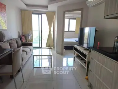 Modern living room with sleek furniture and large windows offering natural light and a view.