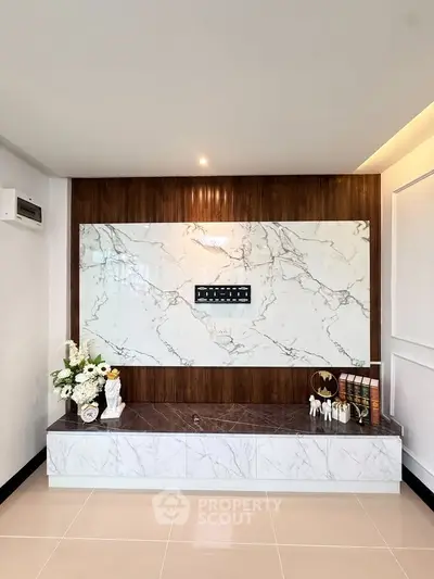 Luxurious modern living room with elegant marble wall and stylish decor