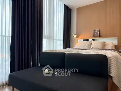 Luxurious bedroom with floor-to-ceiling windows and elegant decor in modern apartment.