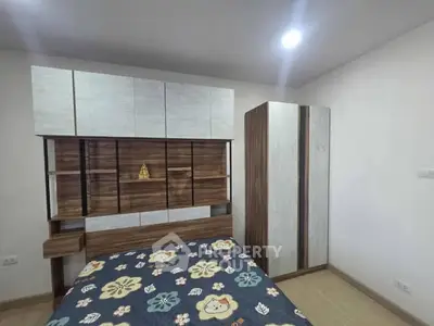 Modern bedroom with stylish wooden furniture and floral bedding