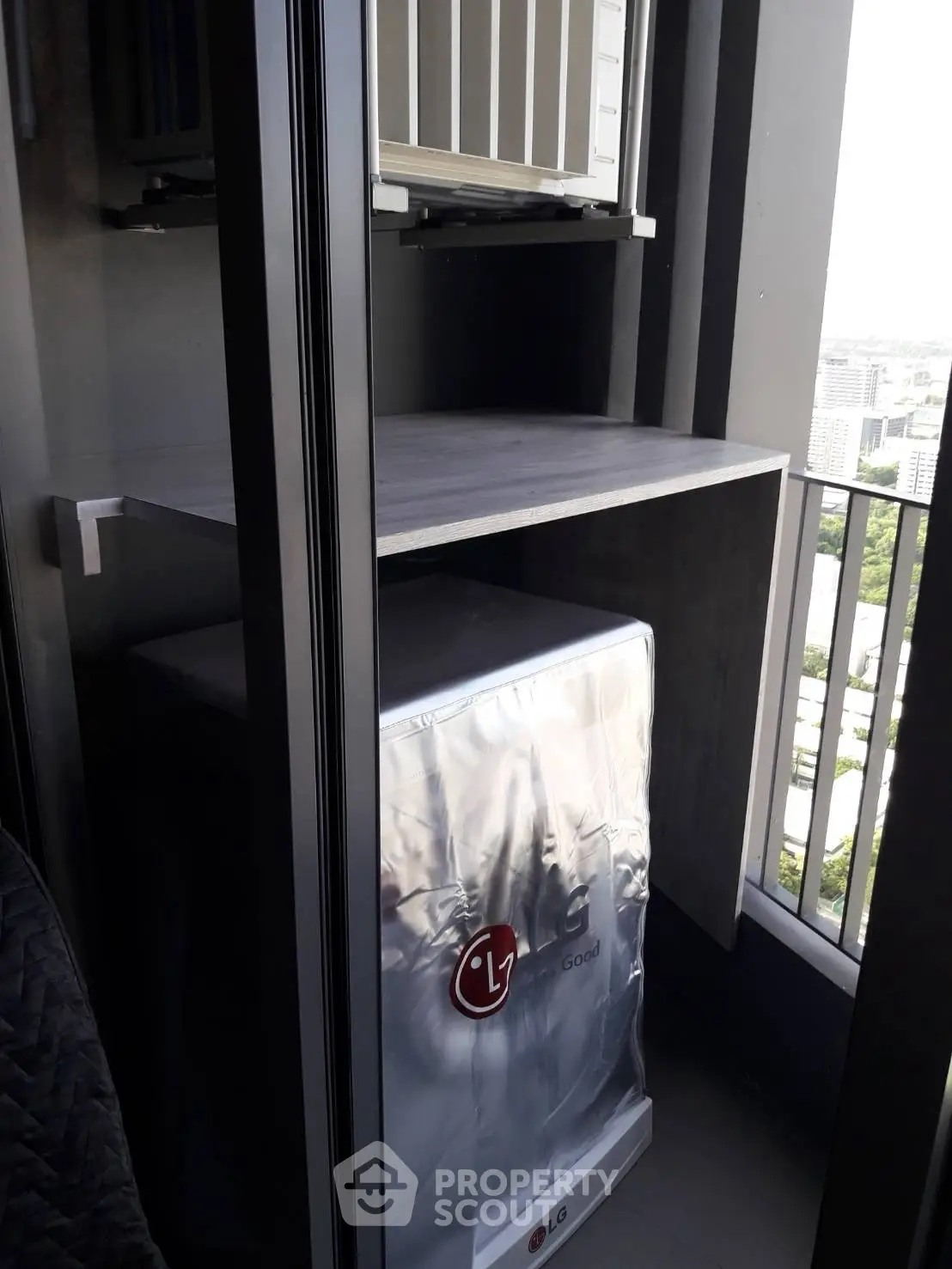 Compact balcony with LG washing machine and city view