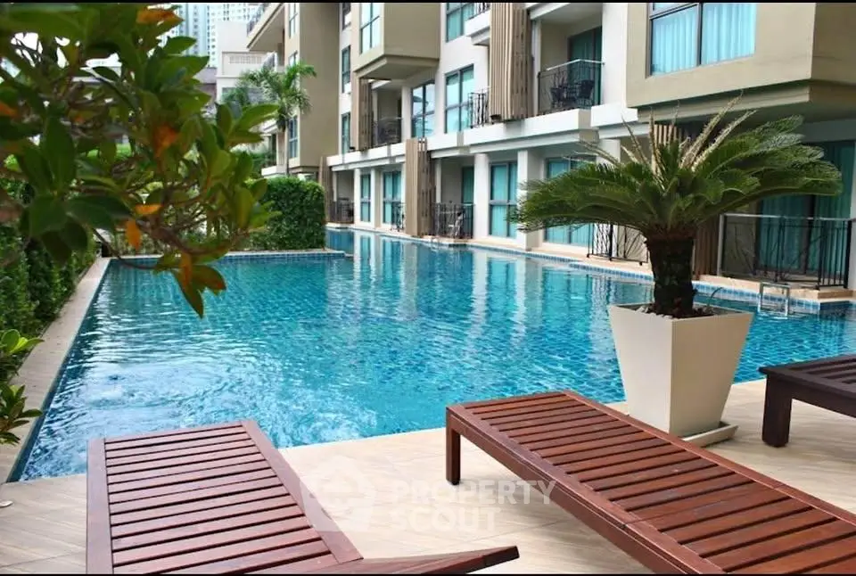 Luxurious apartment complex with a stunning poolside view and modern amenities.