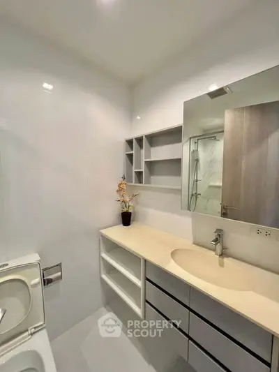 Modern bathroom with sleek vanity and mirror in a contemporary apartment