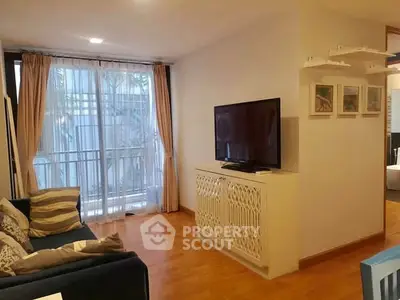 Cozy living room with modern decor and large TV, perfect for relaxation.