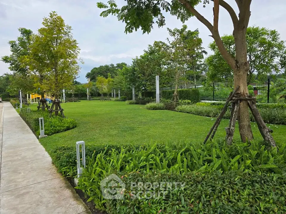 Beautiful landscaped garden with lush greenery and trees in a serene residential area.
