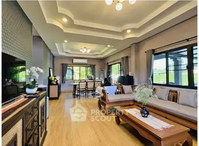 Spacious living room with elegant decor and large windows offering natural light.