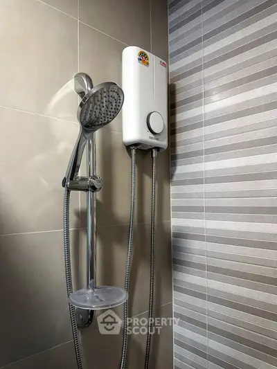 Modern bathroom with sleek showerhead and water heater, featuring stylish tile design.
