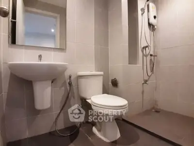 Modern bathroom with sleek fixtures and walk-in shower in a contemporary apartment.