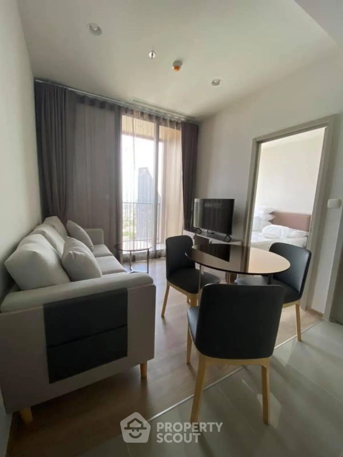 Modern living room with cozy furniture and natural light in a stylish apartment.