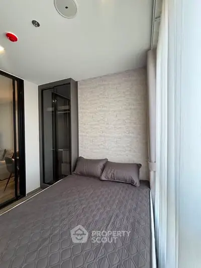 Modern bedroom with stylish decor and large window for natural light