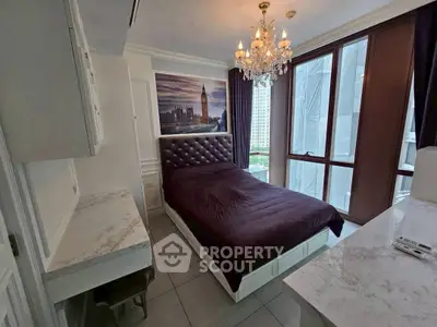 Luxurious bedroom with chandelier and city view, featuring elegant decor and large windows.