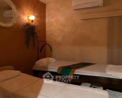 Cozy massage room with ambient lighting and comfortable massage tables, perfect for relaxation and rejuvenation.
