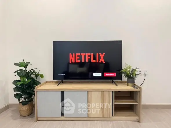 Modern living room with sleek TV stand and Netflix on screen, perfect for entertainment enthusiasts.