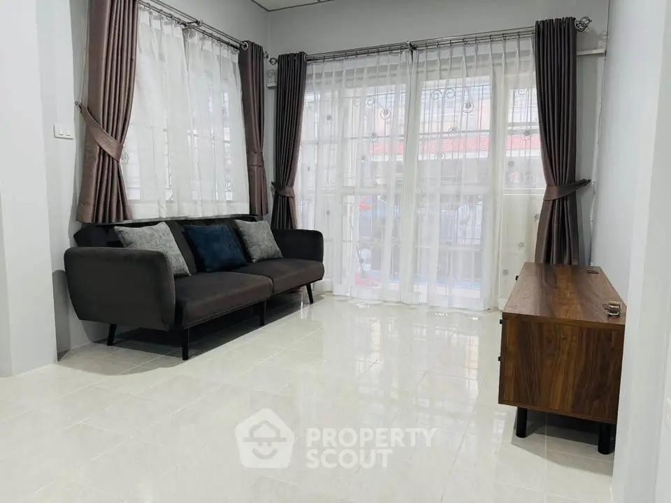 Spacious living room with modern sofa and elegant curtains