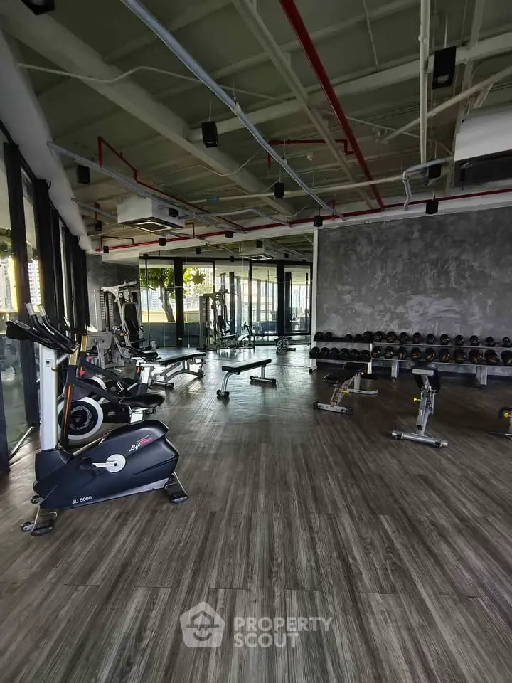 Spacious modern gym with state-of-the-art equipment and sleek design.