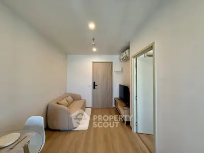 Modern living room with cozy sofa and wooden flooring in a stylish apartment.