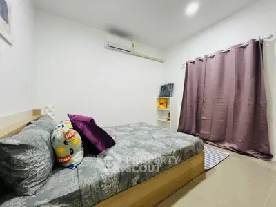 Cozy bedroom with modern decor and air conditioning in a stylish apartment.