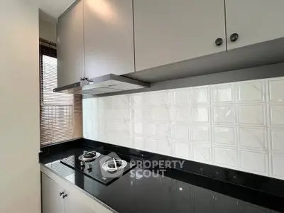 Modern kitchen with sleek black countertop and gas stove