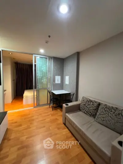 Cozy apartment living room with modern decor and sliding door to bedroom