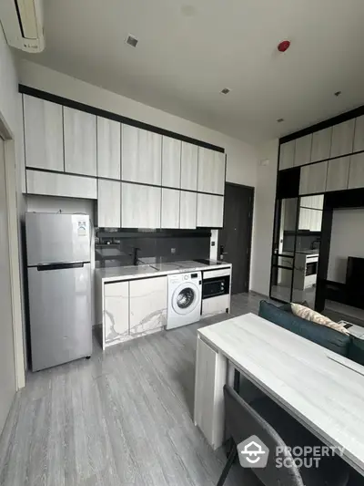 Modern kitchen with sleek cabinetry and built-in appliances in a stylish apartment