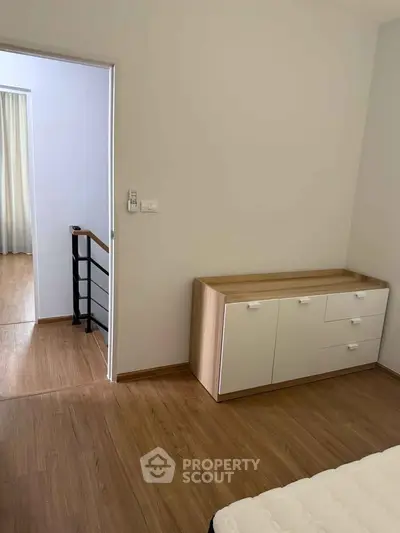Modern bedroom with wooden flooring and minimalist furniture design