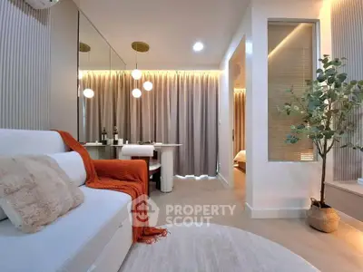 Modern living room with cozy decor and elegant lighting in a stylish apartment.