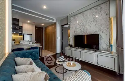 Luxurious modern living room with elegant marble accents and open kitchen layout.