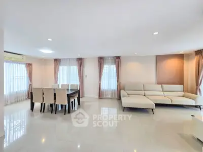 Spacious living room with modern furniture and elegant dining area