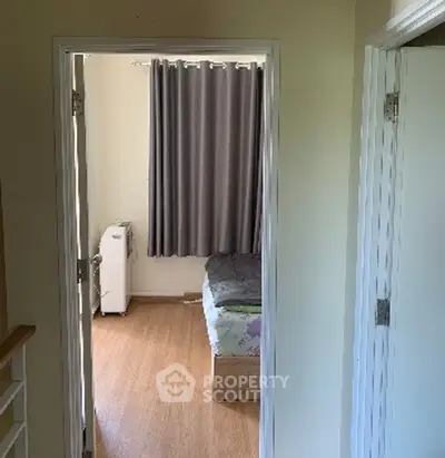 Cozy bedroom with wooden flooring and modern decor