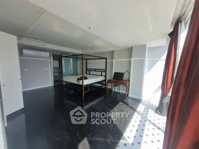 Spacious modern bedroom with large windows and natural light