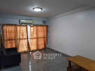 Spacious living room with natural light and modern furnishings, perfect for relaxation and entertaining.