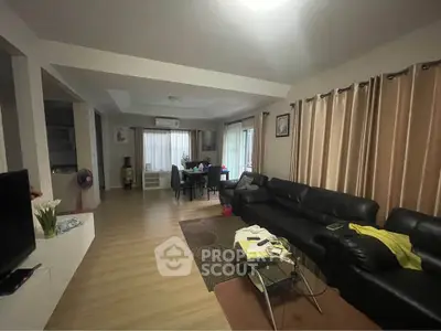 Spacious living room with modern decor and ample natural light