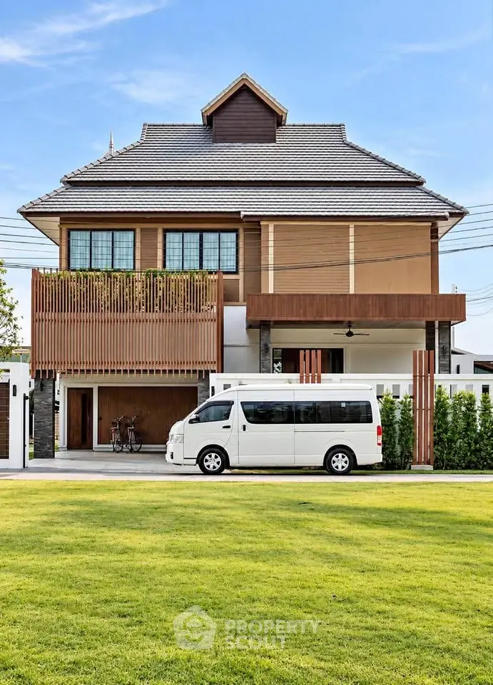 Stunning modern two-story house with spacious lawn and van parked in driveway.
