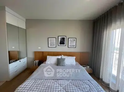 Modern bedroom with stylish decor and large window for natural light
