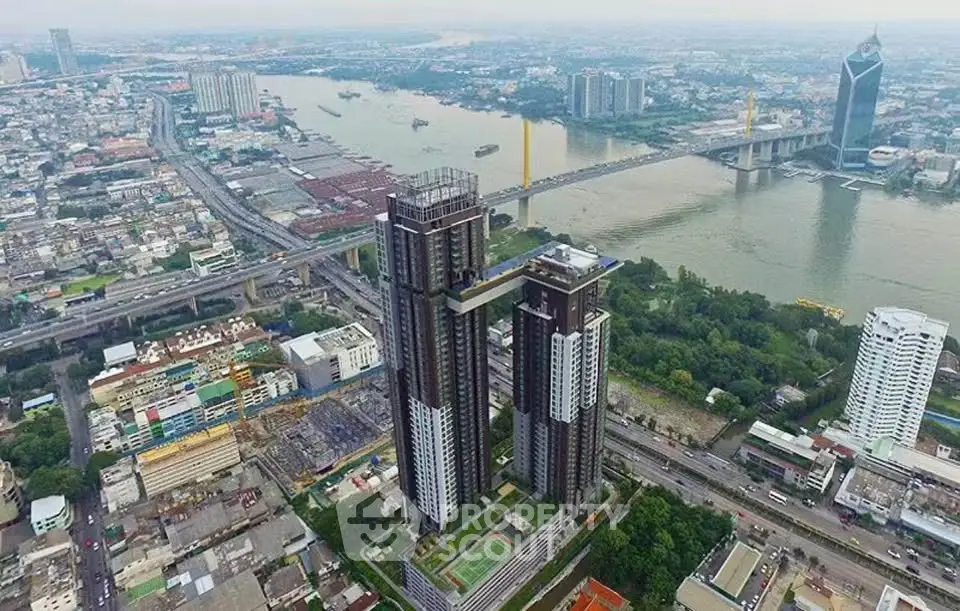 Stunning aerial view of modern high-rise buildings by the river with cityscape backdrop