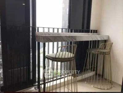 Modern balcony with stylish bar stools and city view, perfect for urban living.