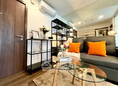 Stylish living room with modern decor and vibrant accents in a cozy apartment.