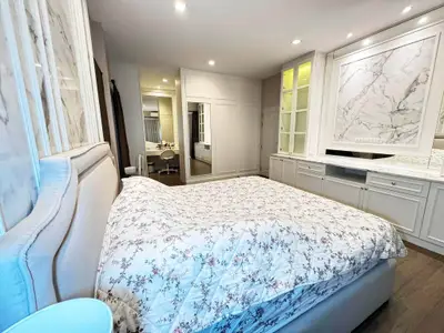 Luxurious bedroom with elegant marble accents and spacious built-in wardrobe