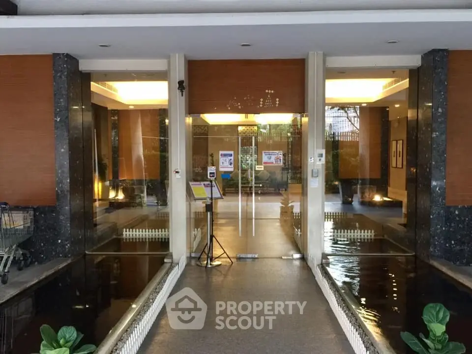 Elegant building entrance with water feature and modern design