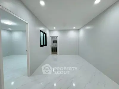 Spacious modern interior with sleek white flooring and minimalist design, perfect for customization.