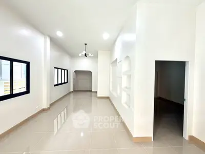 Spacious modern living room with sleek tile flooring and elegant lighting