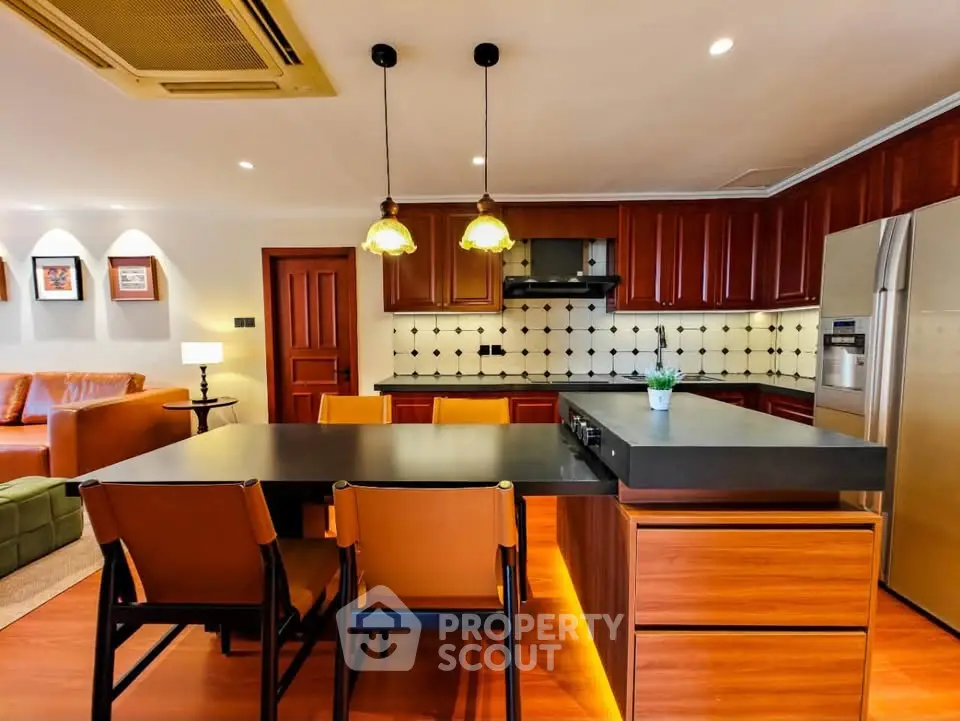 Modern kitchen with sleek cabinetry and island seating in open layout