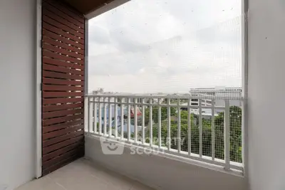 Spacious balcony with city view and safety netting