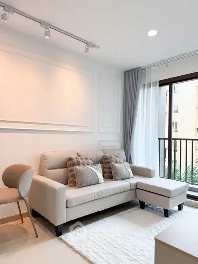 Modern living room with stylish sofa and balcony view